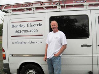 Jay Bentley standing by a company van